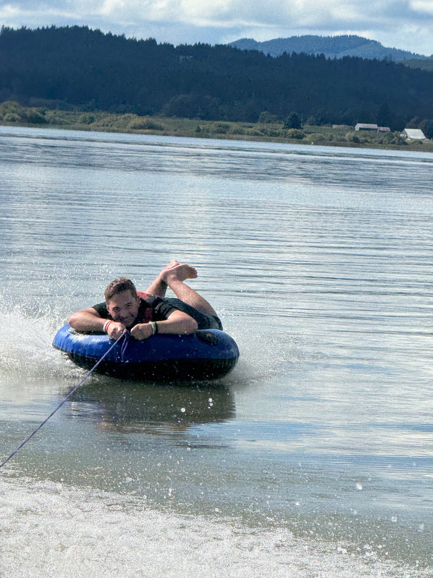 A Connect student tubing across an Oregon lake