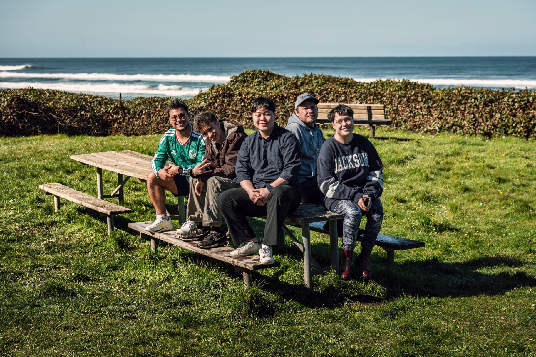 International students gathered at a picnic table by the Oregon coast