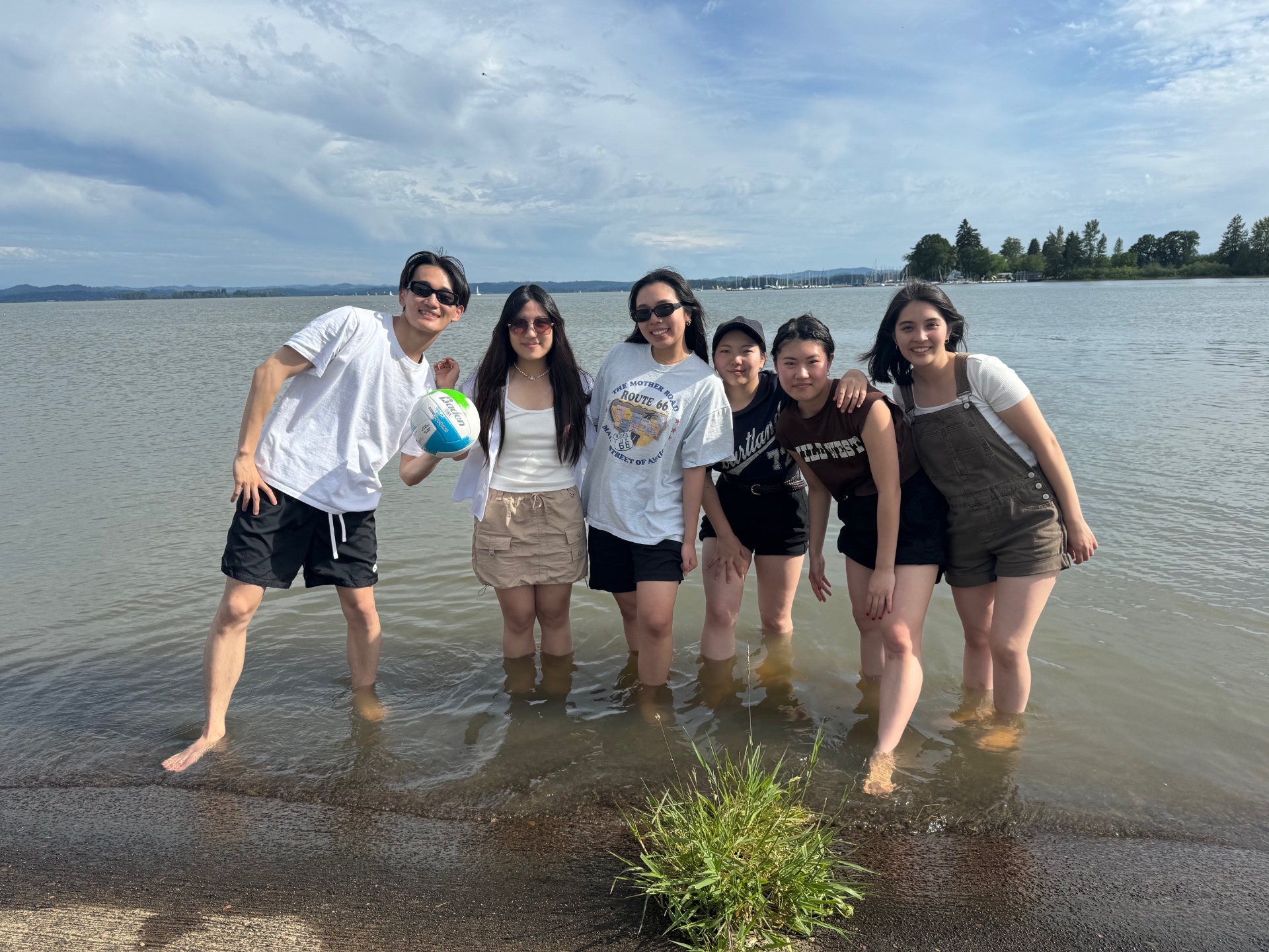 Connect students wading in the lake with a volleyball on a summer day